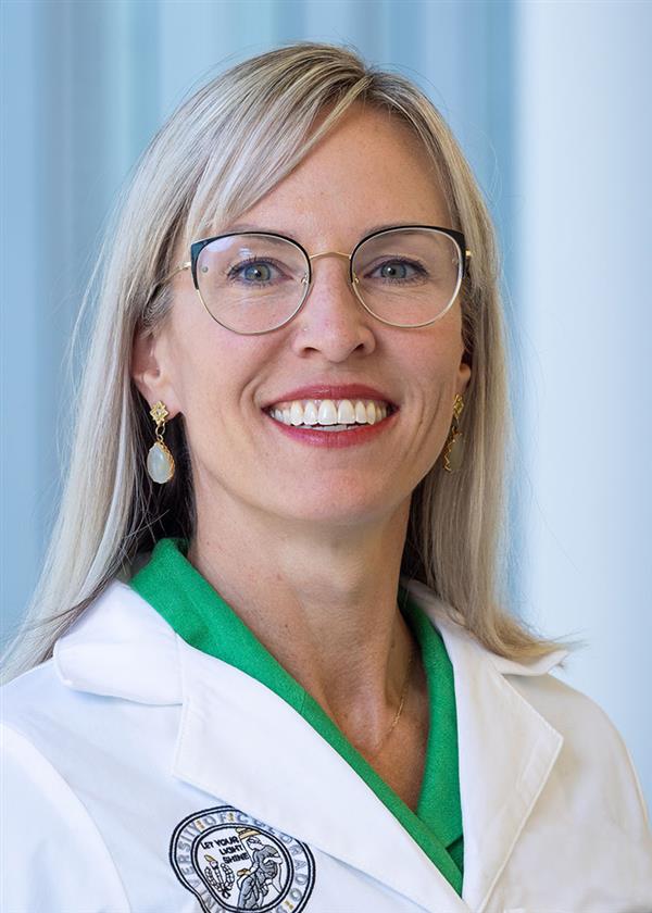 Dr. Camille Hoffman, smiling, in a white coat